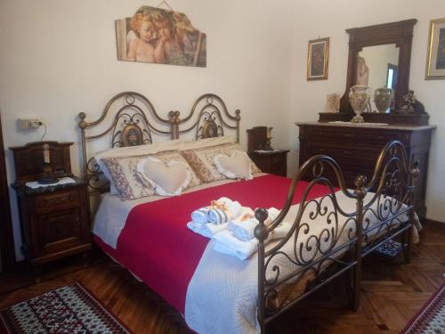 a bedroom with a bed with a doll on it at La casa dei poeti in Cervasca