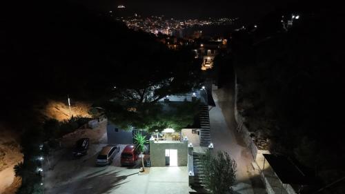 an overhead view of a street at night with cars parked at Green Villa in Sarandë