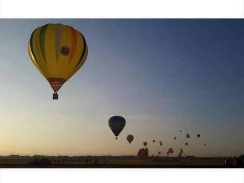 a group of hot air balloons flying in the sky at Hidden Pearl Hotel (Janus Luxury Suites) in Angeles