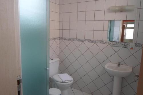 a bathroom with a toilet and a sink at Hotel e Pousada dos Leões in São Luís