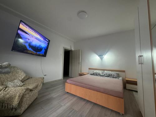 a bedroom with a bed and a tv on the wall at Niki in Čačak