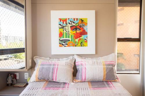 a bedroom with a bed with two pillows at Paraíso do Atlântico #102D - Estilo por Carpediem in Ilha da Restinga