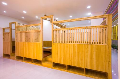 a gym with wooden stalls in a room at Alaya Stays Miyabi Suites, Golf Course Road in Gurgaon