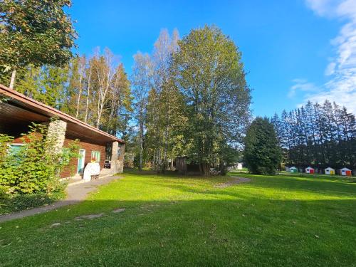 a woman walking through a yard next to a house at Penzion Poslední míle in Milovy