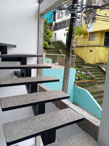 a view from the balcony of a building with benches at Hostal Ninfa del Mar in Manizales