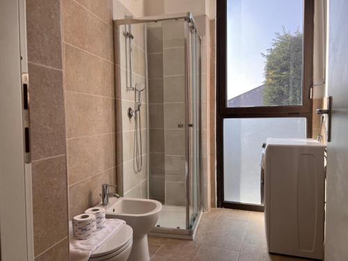 Un baño con ducha, inodoro y lavabo. en Kibilù - Via Pompeo Mariani, en Milán