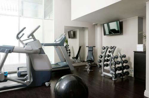 a gym with several tread machines and a simulator at Hotel Haven in Helsinki