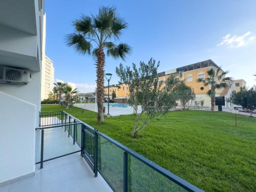 a balcony with a view of a park at Ground Garden View Apartments in Caesar Resort & SPA, Long Beach in Perivolia tou Trikomou