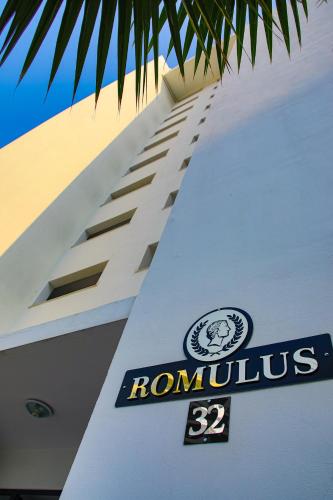 a building with a romanolis sign on the side of it at Ground Garden View Apartments in Caesar Resort & SPA, Long Beach in Perivolia tou Trikomou