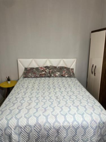 a bedroom with a bed with a white bedspread at Apartamento PORTO DAS DUNAS in Aquiraz