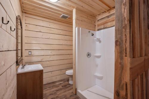 a bathroom with a toilet and a sink at Birch Glen Hotel in Cascade