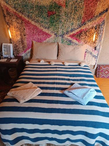 a large bed with two towels on top of it at Kasbah Oulad Othmane in Agoubt