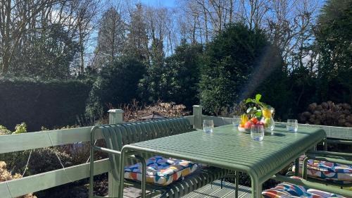 a green table with a bowl of fruit on it at The Shades - Bliss In The Heart of Windermere in Windermere