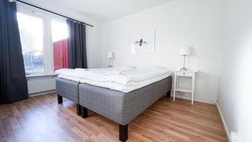 a large bed in a room with a window at Karlskoga Folkhögskola Vandrarhem Udden in Karlskoga