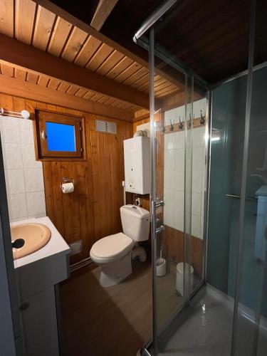 a bathroom with a toilet and a sink and a shower at Chalet 5 personnes California Park in Cabourg
