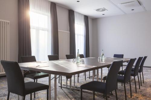 a conference room with a long table and chairs at Candlewood Suites Augsburg in Augsburg