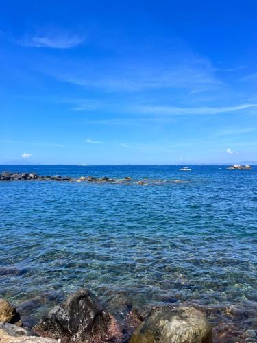 a view of the ocean with rocks in the water at Le terrazze in Massa Lubrense