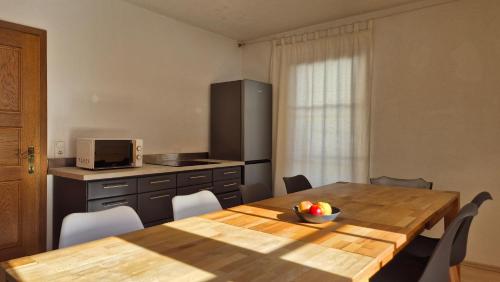 a kitchen with a wooden table with a bowl of fruit on it at Alina's DIY-Haus St.Jakob in Innere Großrotte
