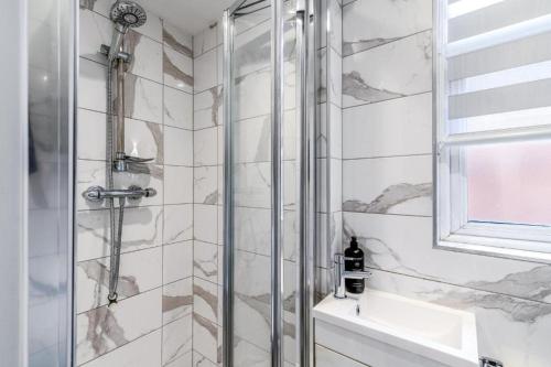 a bathroom with a shower and a sink at Tranquil Studio Retreat in Harrow in Harrow