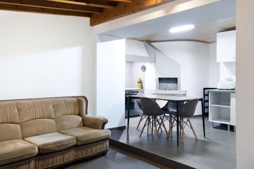 a living room with a couch and a table at Blue Ocean View in São Roque do Pico