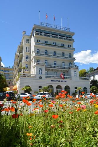a hotel with a field of flowers in front of it at Best Western Hotel Bellevue au Lac in Lugano