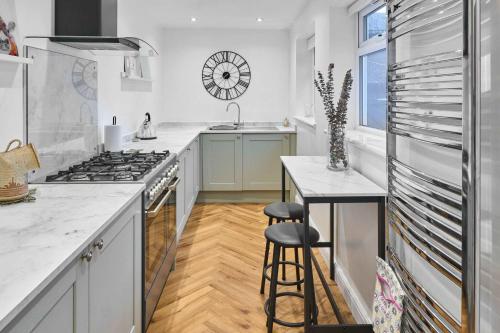 a kitchen with a counter and a sink and a stove at Host & Stay - Railway Cottages in Liverpool