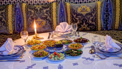 a table with plates of food on a table at Riad Salam Fes in Fès