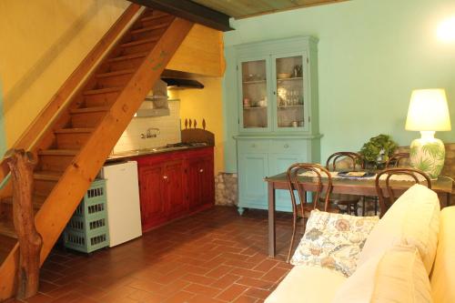 a kitchen with a staircase and a table in a room at Agriturismo & Winery Il Bacio in Tavarnelle in Val di Pesa