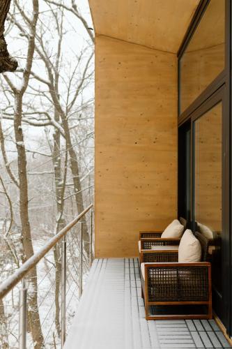 a house in the woods with a balcony at Villa Marrakesh Noszvaj in Noszvaj