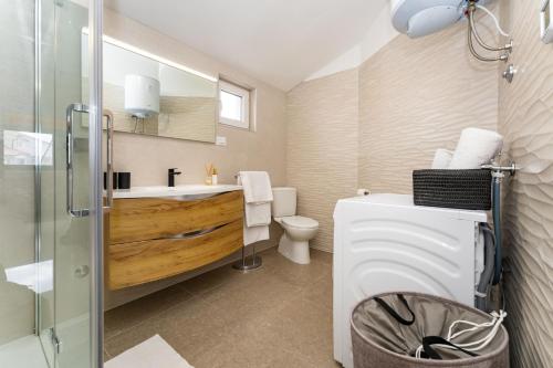 a bathroom with a toilet and a sink and a shower at Sea View Apartment Betina, Murter in Betina