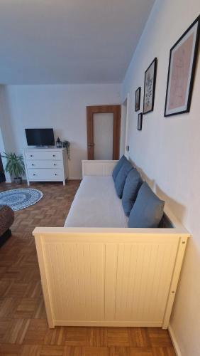 a bedroom with a large white bed with blue pillows at Ferienwohnung Schloßberg 1 in Peiting