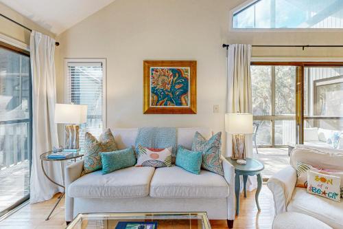 a living room with a couch and some windows at Parkside 4518 in Kiawah Island