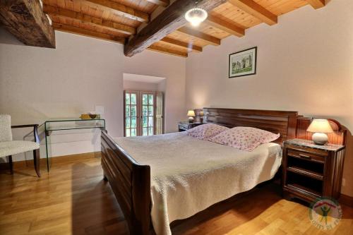 a bedroom with a large bed and a desk at La loge du bourg in Lanrigan