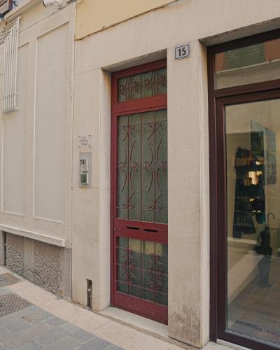 a red door on the side of a building at Magnifica Terrazza - Lake View in Gardone Riviera