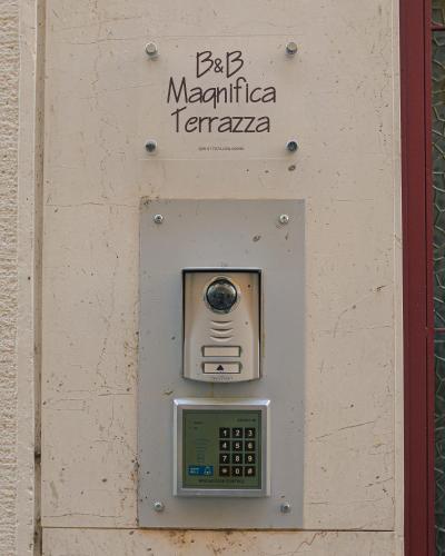 a pay phone on the side of a wall at Magnifica Terrazza - Lake View in Gardone Riviera