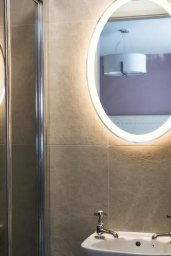 a bathroom with a sink and a mirror at The Monks Quarters in Quin