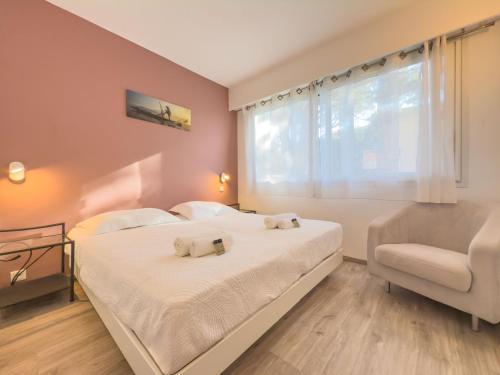 une chambre avec deux lits et une chaise et une fenêtre dans l'établissement Le Cozy by Winsome Destination, à Cannes