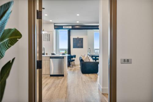 an open door to a kitchen and a living room at 2BR, King Bd, Free Prkn, Gym, NYC View, 8min Train in East Orange