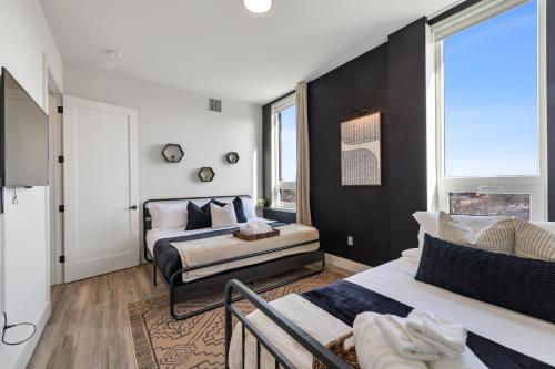 a bedroom with two beds and a window at 2BR, King Bd, Free Prkn, Gym, NYC View, 8min Train in East Orange
