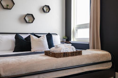 a bedroom with a bed with a basket on it at 2BR, King Bd, Free Prkn, Gym, NYC View, 8min Train in East Orange