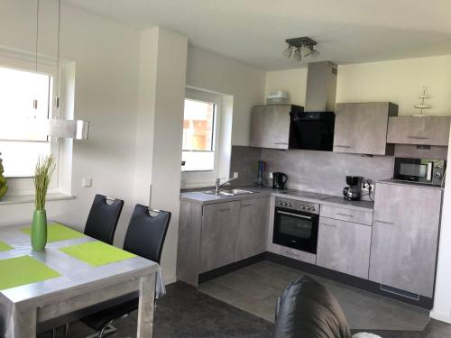 a kitchen with a table and a dining room at Deichkieker in Butjadingen