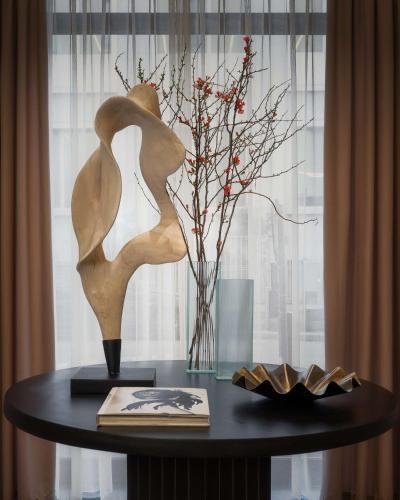 a table with a sculpture of a woman on it at WorldHotel Casati 18 in Milan