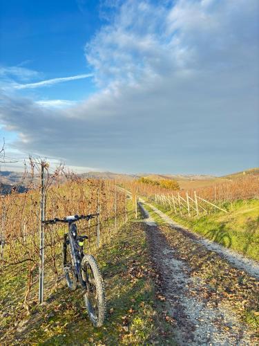 a bike parked on the side of a dirt road at La Capinera Sabry's Home in Vezza d'Alba