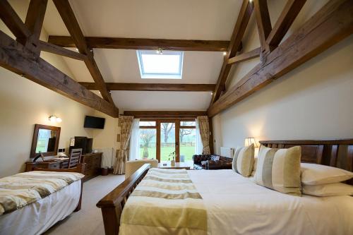 a large bedroom with two beds and a window at Green Grove Country House in Malham