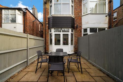 a patio with chairs and a table on a balcony at Tranquil Studio Retreat in Harrow in Harrow