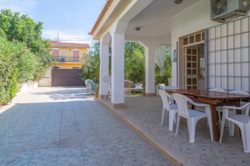a patio with a wooden table and chairs at Villa Amore - San Lorenzo in San Lorenzo