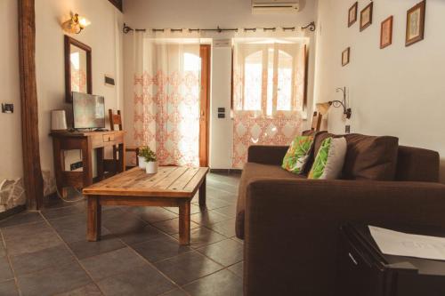 a living room with a couch and a coffee table at Agriturismo Terrenia in Taormina
