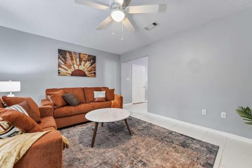a living room with a couch and a ceiling fan at Sunset Getaway Spacious Retreat Near Beaches & Local Attractions in Gulfport