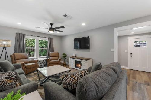a living room with a couch and a fireplace at Coastal Casa -Charming 3 Bedroom House in Gulfport