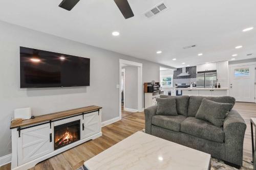 a living room with a couch and a fireplace at Coastal Casa -Charming 3 Bedroom House in Gulfport